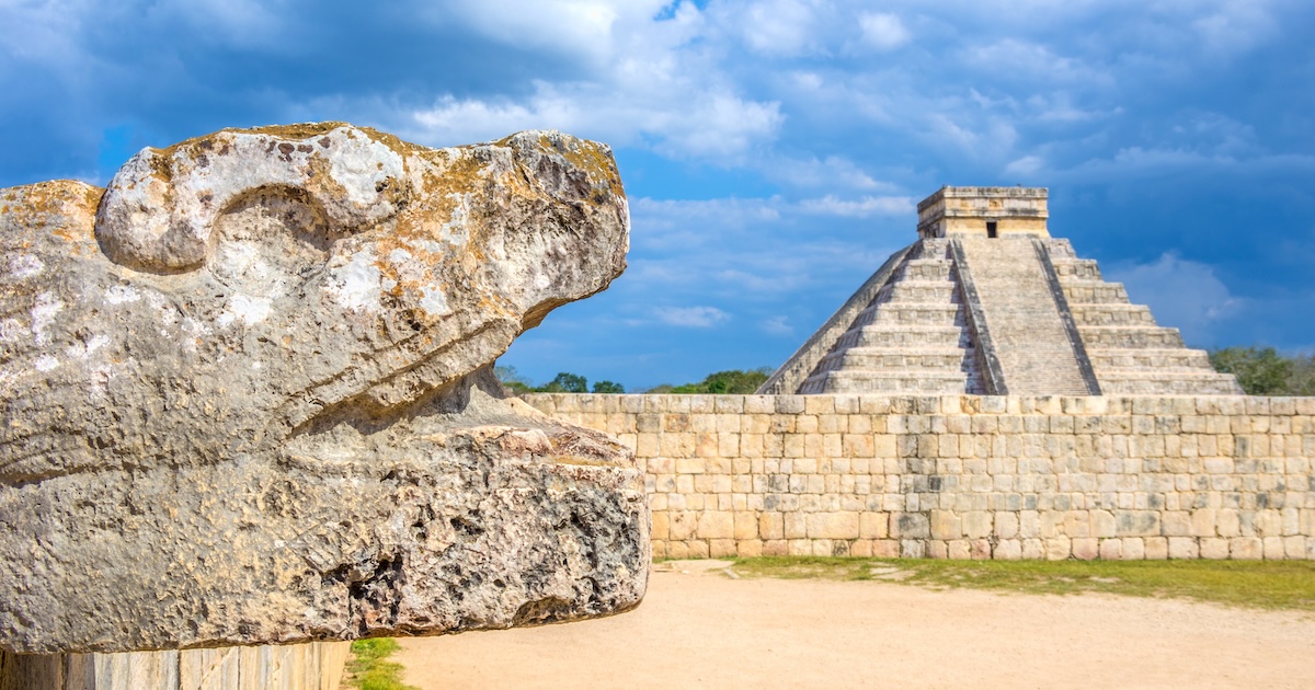 Chichen Itza pyramid and mayan head sculpture,Mexico